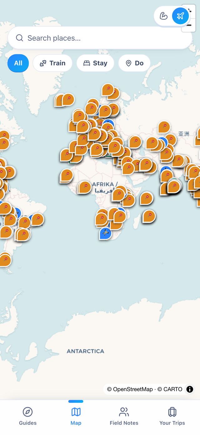 World map in the app covered in pins for stays, gyms and things to do