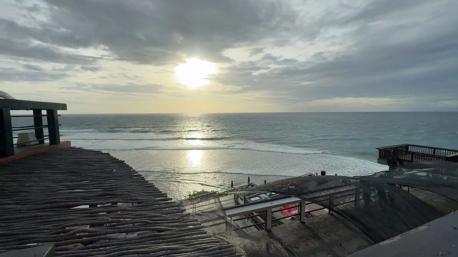 The sun low over the surf at Uluwatu, seen from the cliff terraces