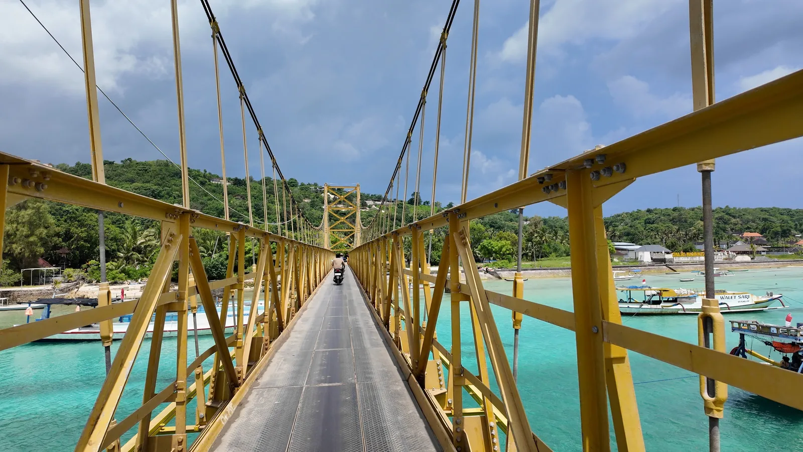 The yellow suspension bridge between Nusa Lembongan and Nusa Ceningan over turquoise water