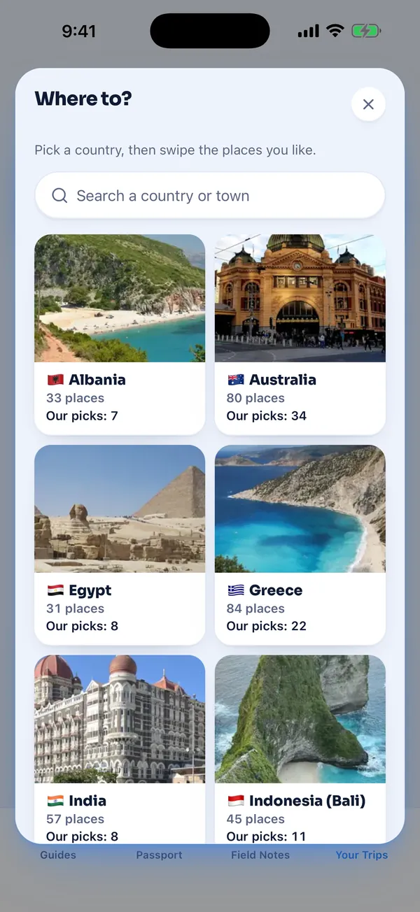 The Where to screen in the Fit Nomads app: a search box that says Search a country or town, above photo tiles for Albania, Australia, Egypt, Greece, India and Bali, each with a count of places and our picks.