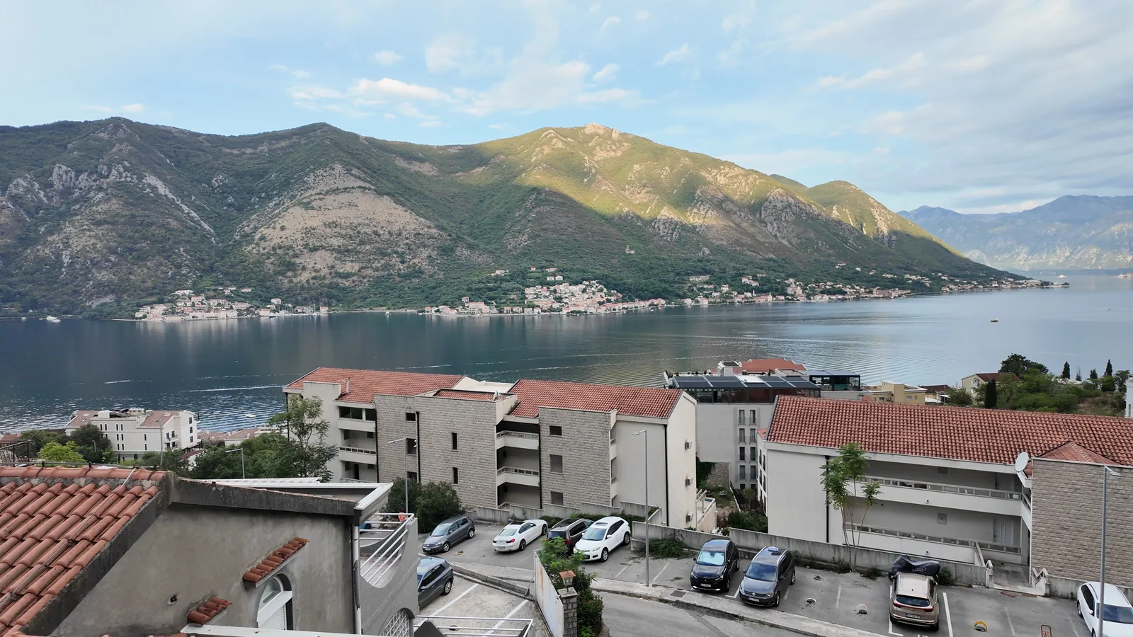 The Bay of Kotor and the mountains over the red rooftops of Dobrota