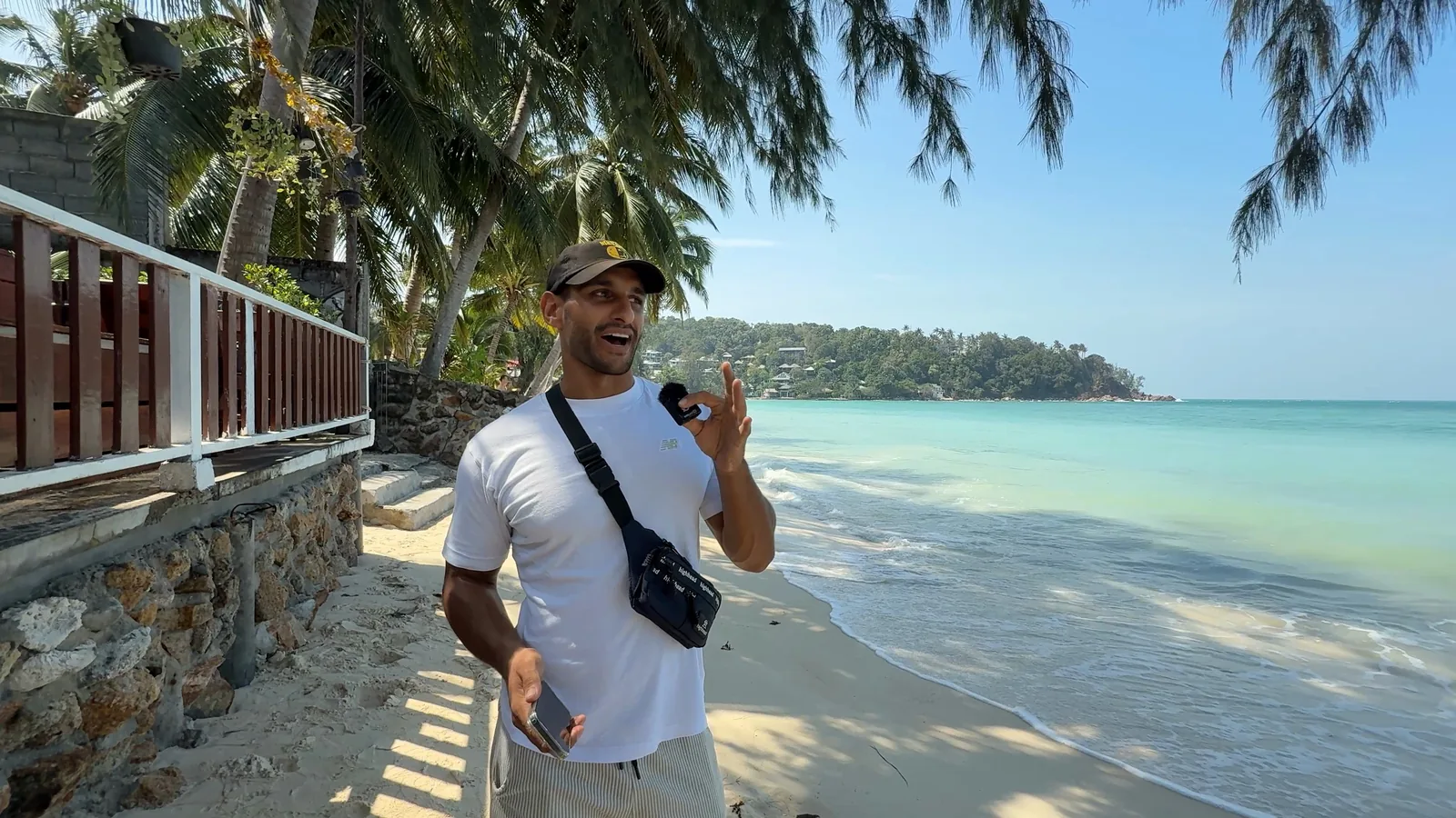 Tijs on a quiet white beach on Koh Phangan, palms over the sand and clear water