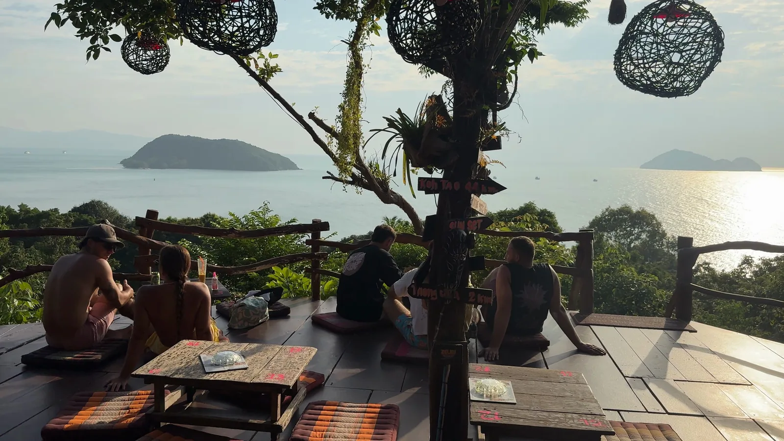 The wooden deck at Top Rock Bar with hanging lanterns, looking out over the sea to small islands